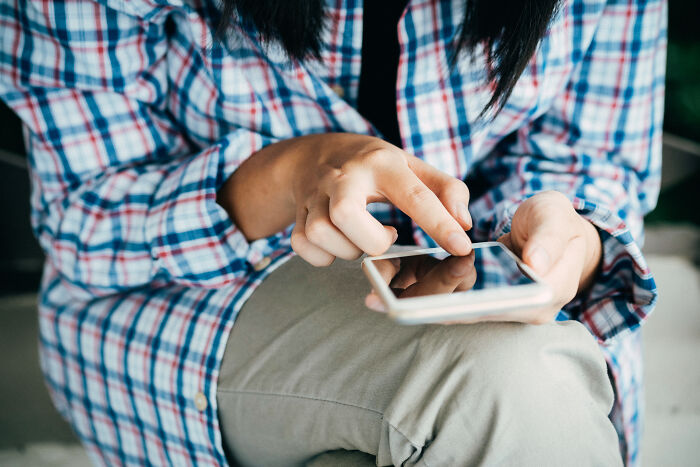 woman touching the mobile screen by her finger