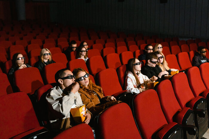 people in glasses for movie sitting in the cinema