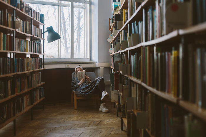 woman reading a book in the library