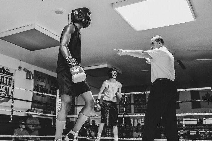 two boxers and the judge on the ring