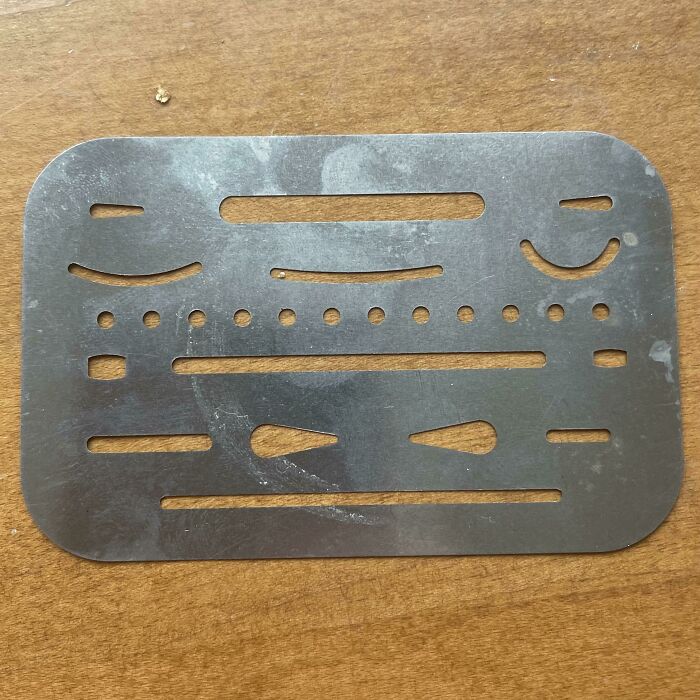 Thin Piece Of Metal With A Group Of Varying Hole Types