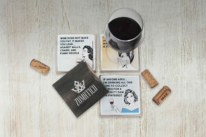 glass of wine with sarcastic coasters 