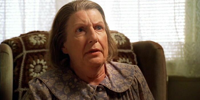 Livia Soprano is sitting in an armchair