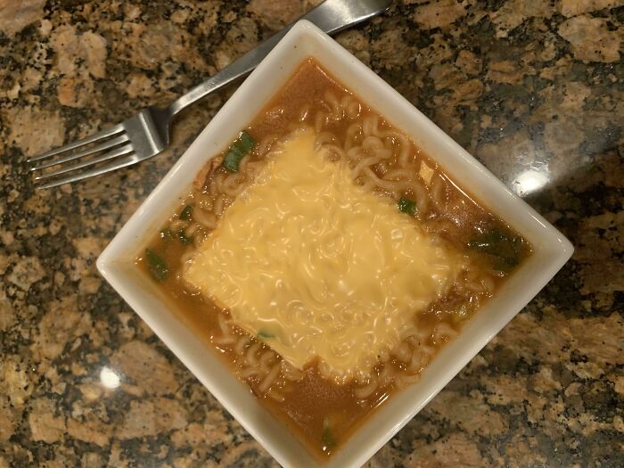 Bowl of ramen with melted cheese slice