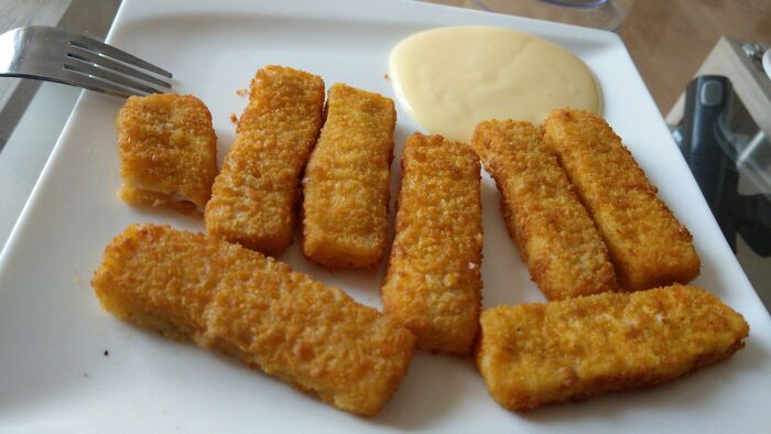 Plate of fish fingers and custard sauce