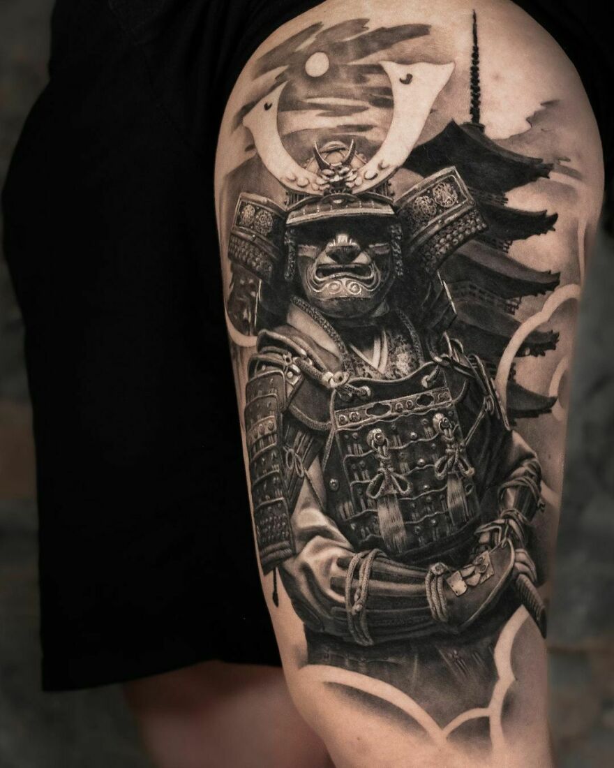 Super realistic tattoo of a Japanese samurai with a pagoda in the background, showcasing intricate detailing.