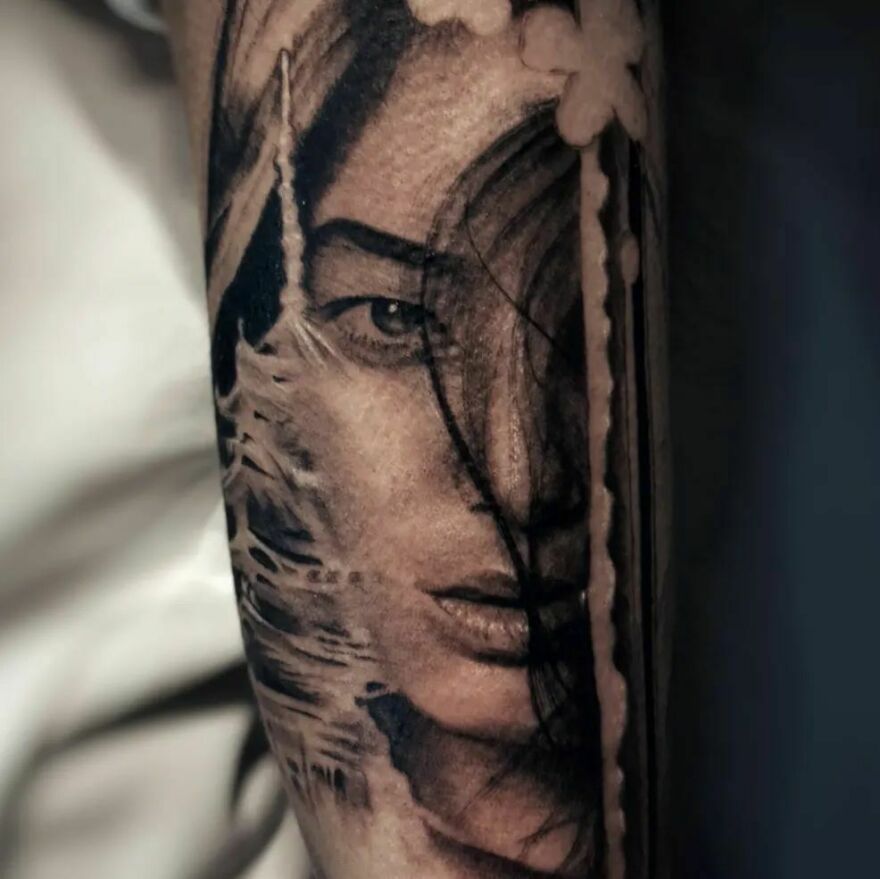 Realistic Japanese-inspired woman portrait tattoo with detailed shading and intricate design elements.