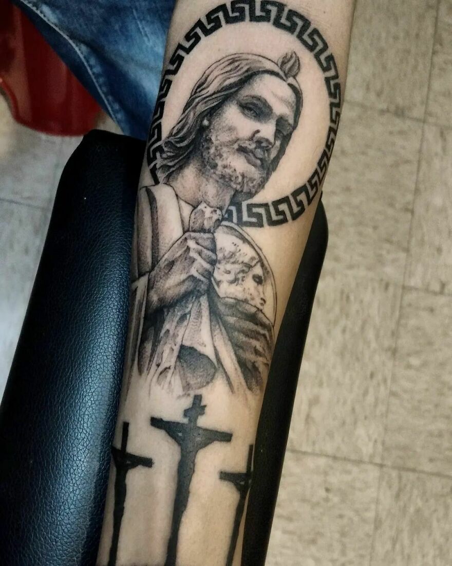 "Realistic San Juditas tattoo showcasing intricate religious detailing on forearm."