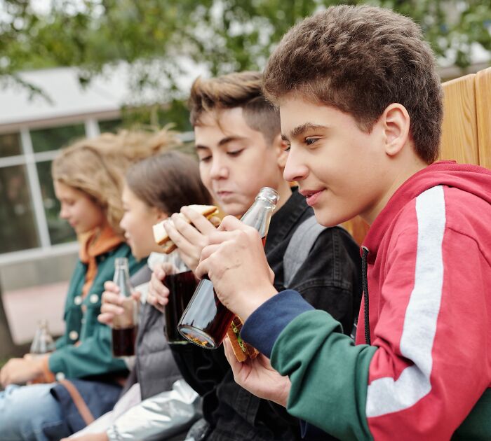 Students Eating And Drinking On Lunch Break 