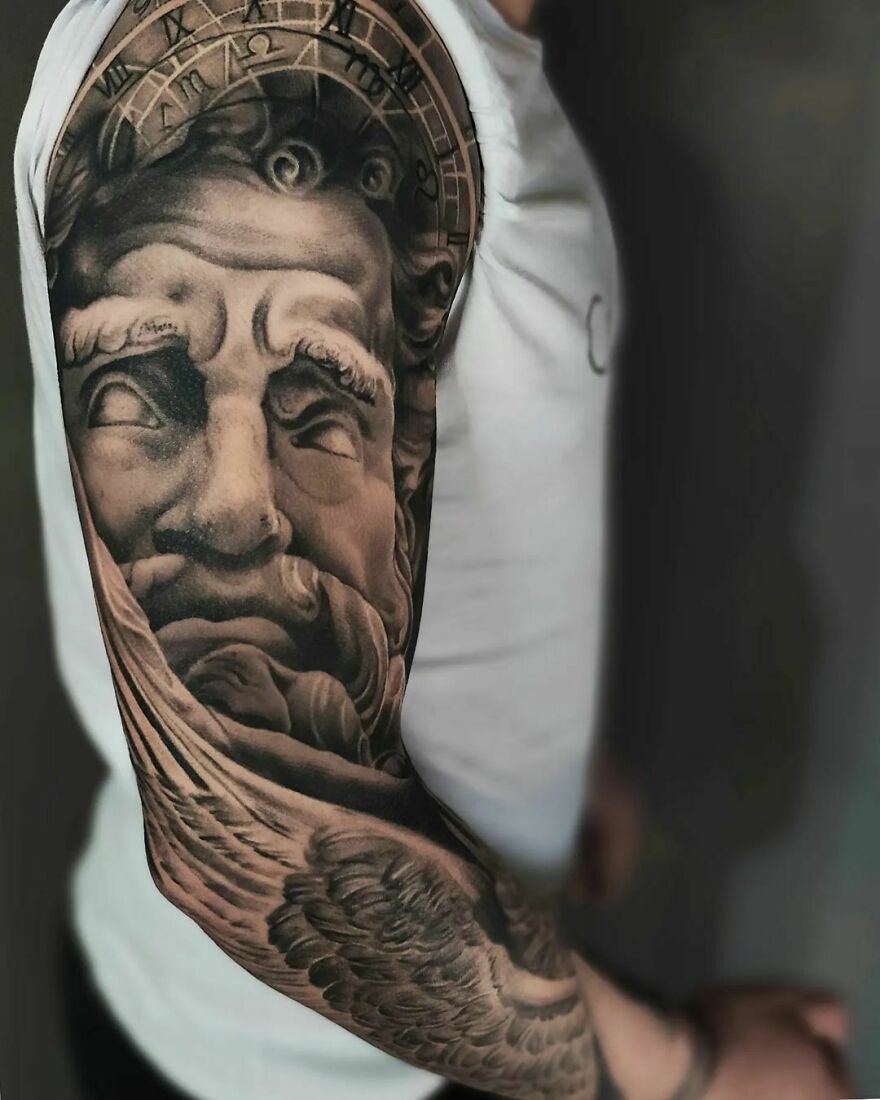 Realistic Greek theme right arm sleeve tattoo with intricate detailing of a deity and symbols.