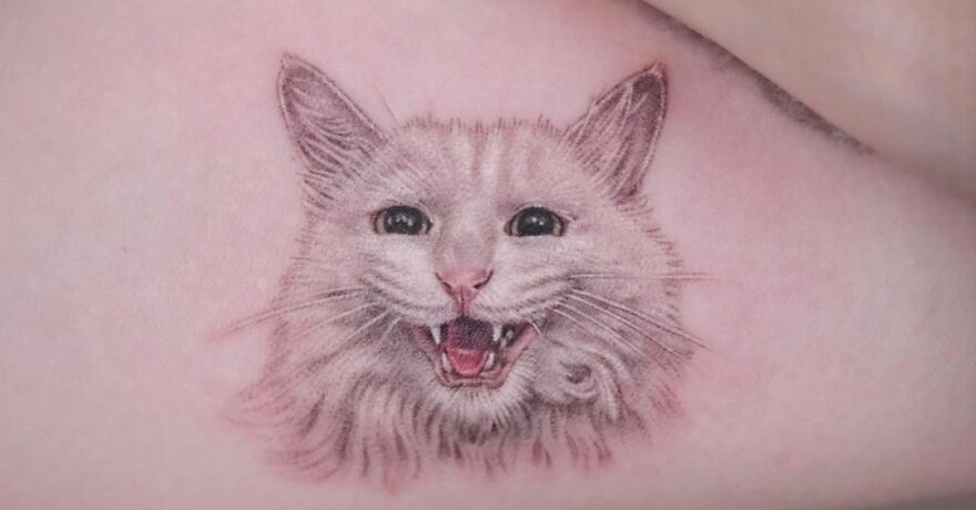 White cat portrait with mouth open tattoo
