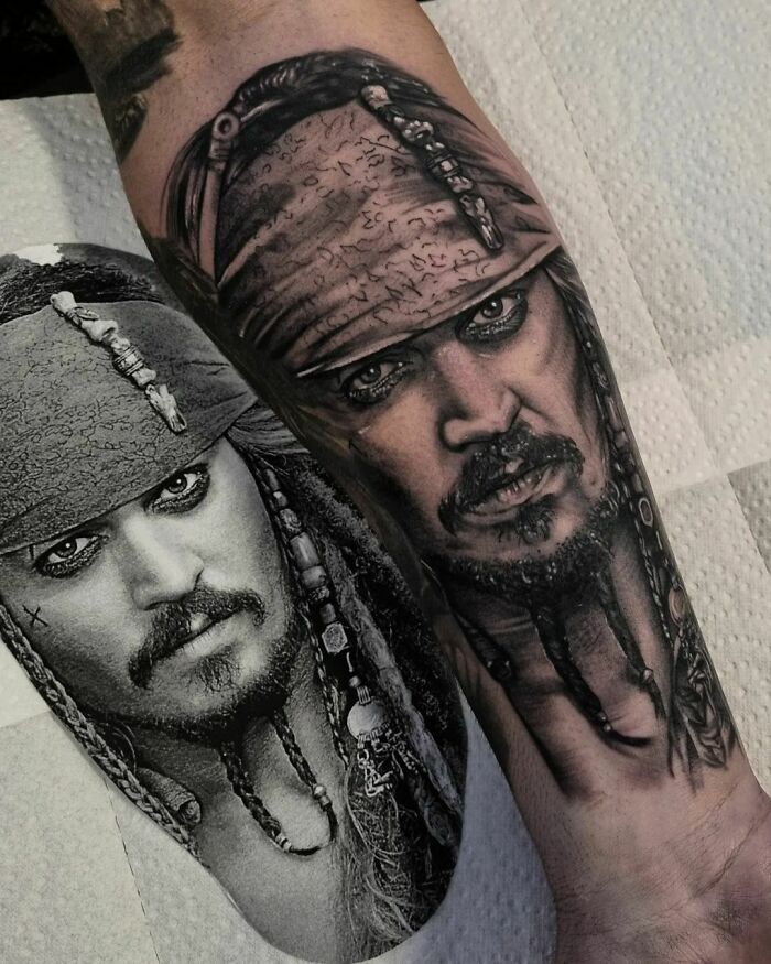 A super realistic tattoo of a pirate character on an arm, showcasing detailed shading and artistry.