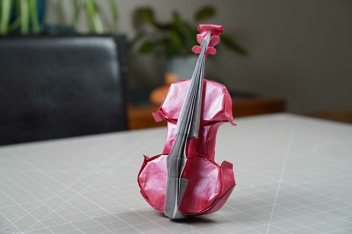 a pink origami violin