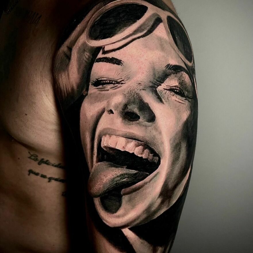 Realistic tattoo of a girl sticking her tongue out, showcasing intricate detailing.