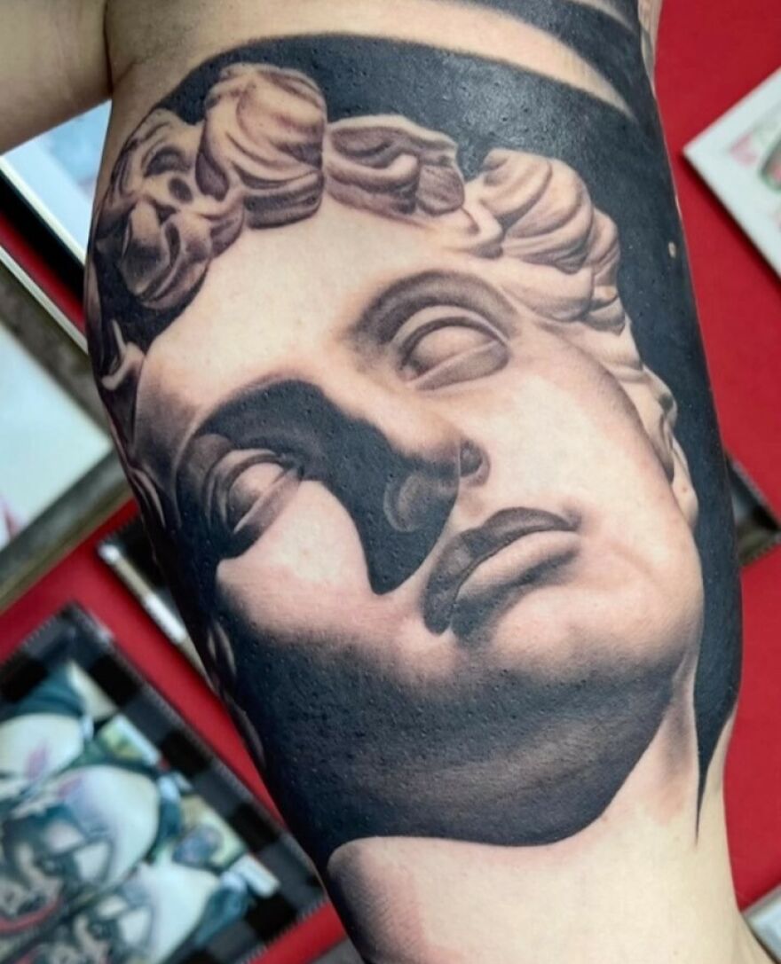 Realistic Medici statue face tattoo, showcasing incredible detailing and artistry.