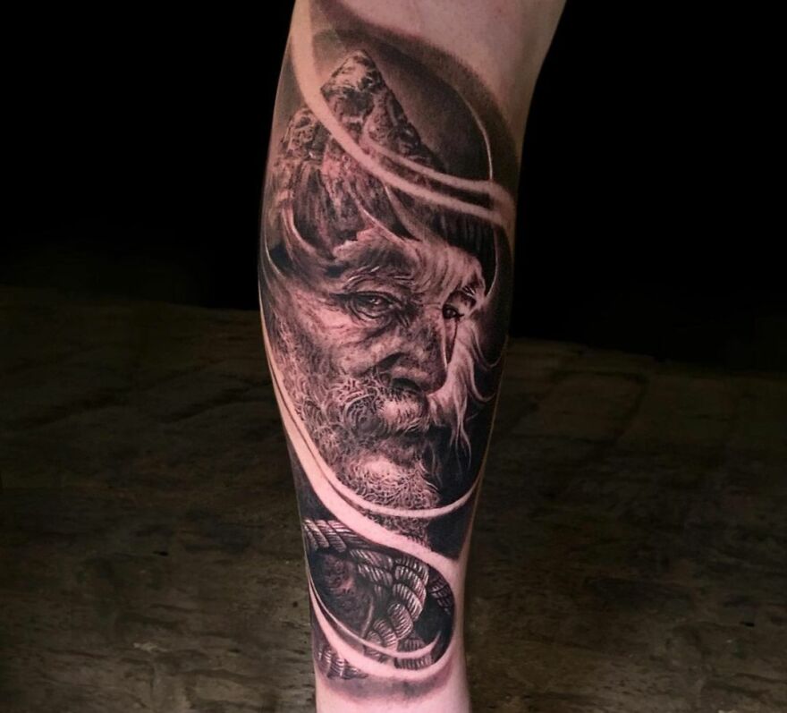 Realistic old man portrait tattoo on a leg, showcasing intricate detailing and artistry.