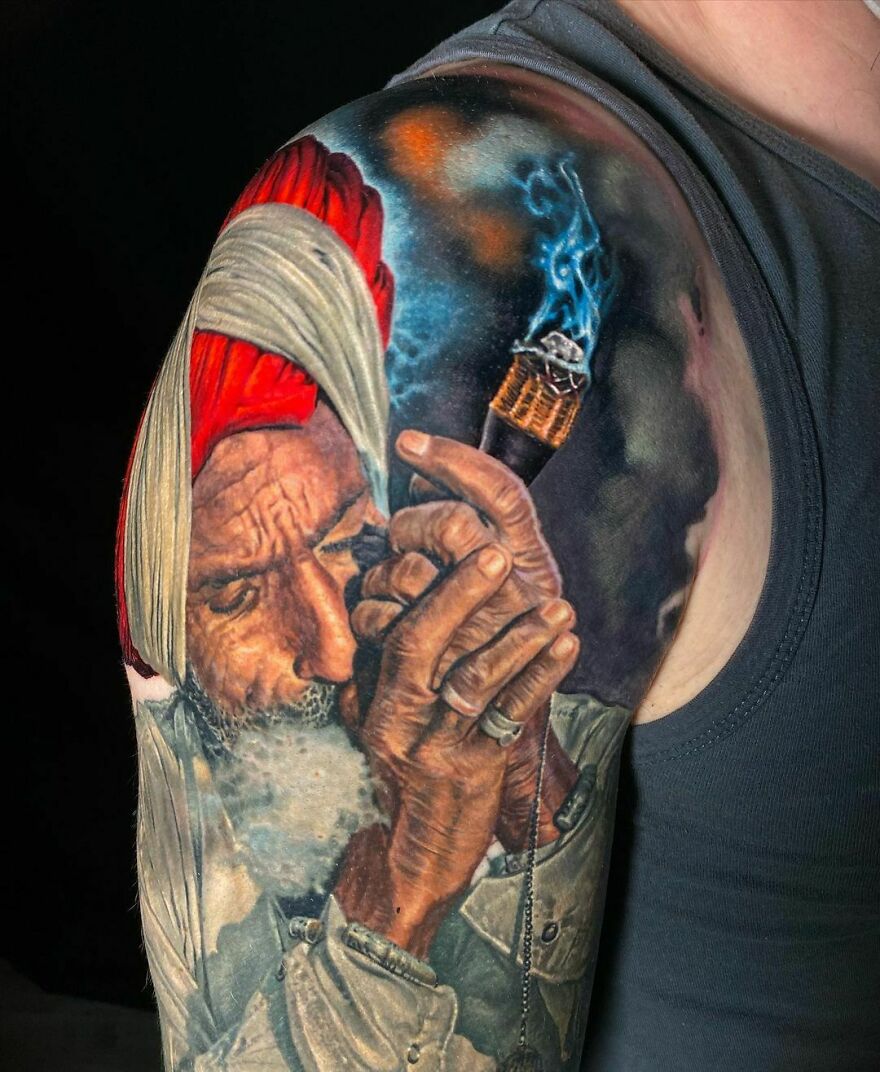 Colorful realistic tattoo of a man smoking a pipe on an arm, showcasing intricate details.
