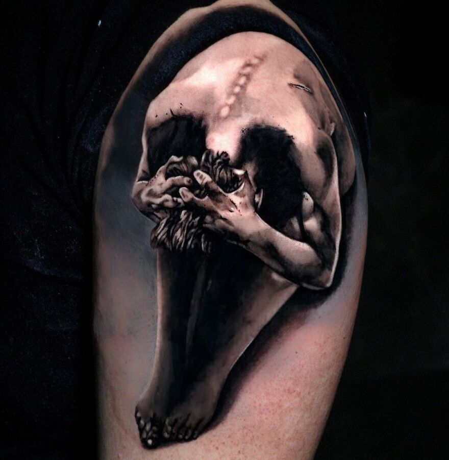 Realistic tattoo of a curled figure on an arm, showcasing intricate shadows and detail, creating a lifelike appearance.