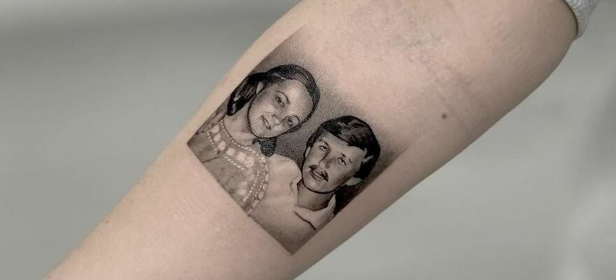 Realistic forearm tattoo of mother and father portraits showcasing detailed artistry.