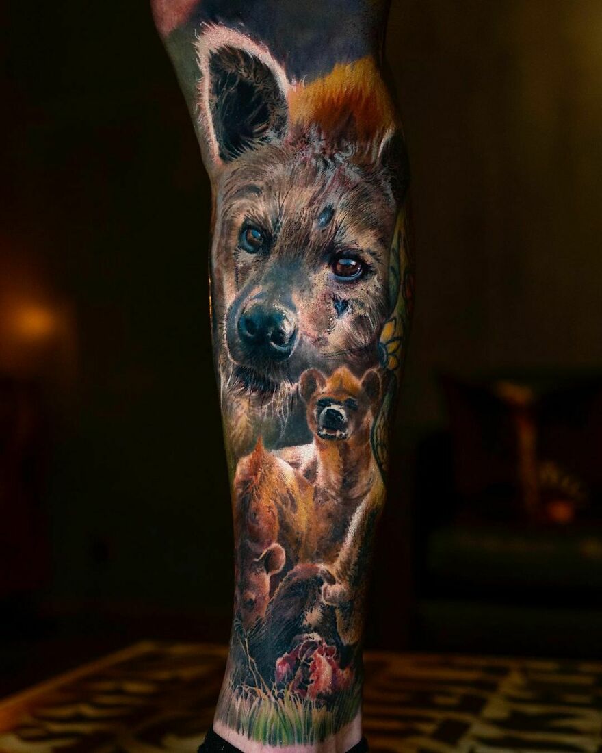 Realistic hyena-themed leg tattoo showcasing detailed artistry and vivid imagery.