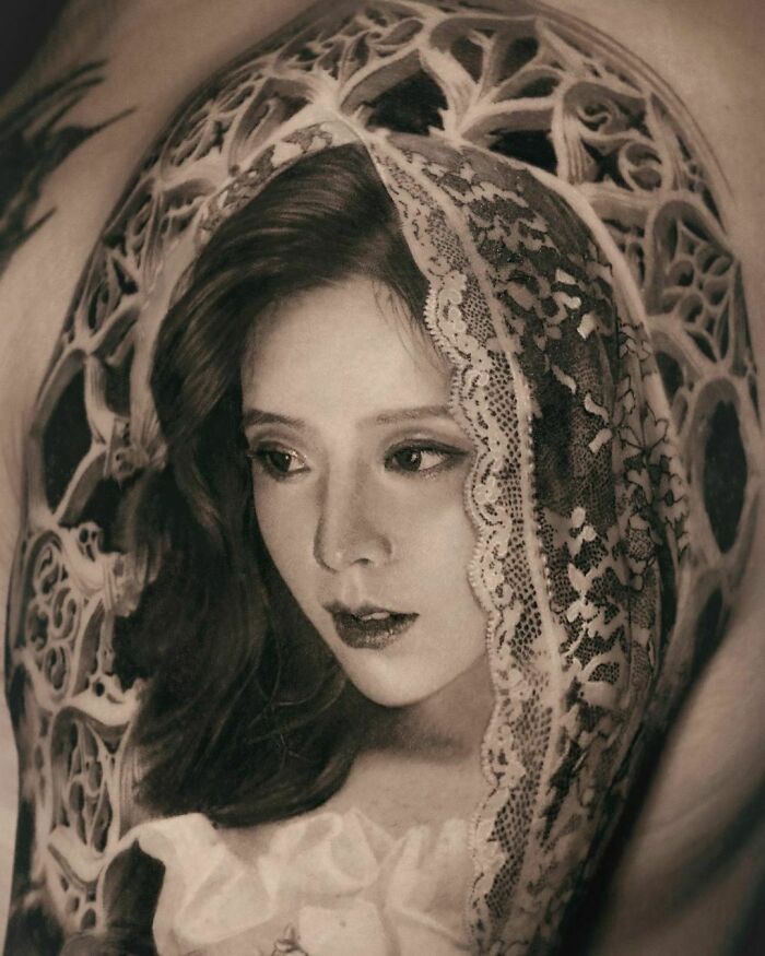 A stunning, realistic tattoo depicting a woman with a lace veil, showcasing incredible artistry and detail.