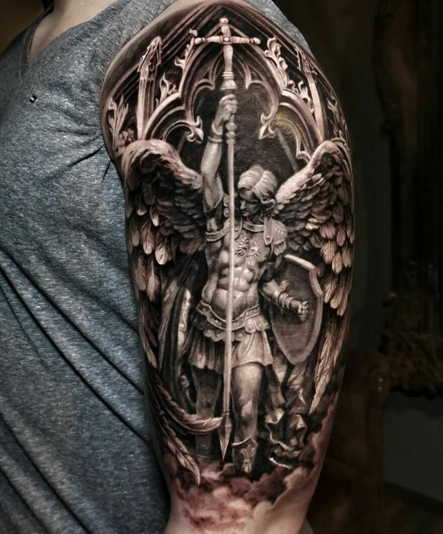 Realistic angel statute with sword in right hand tattoo