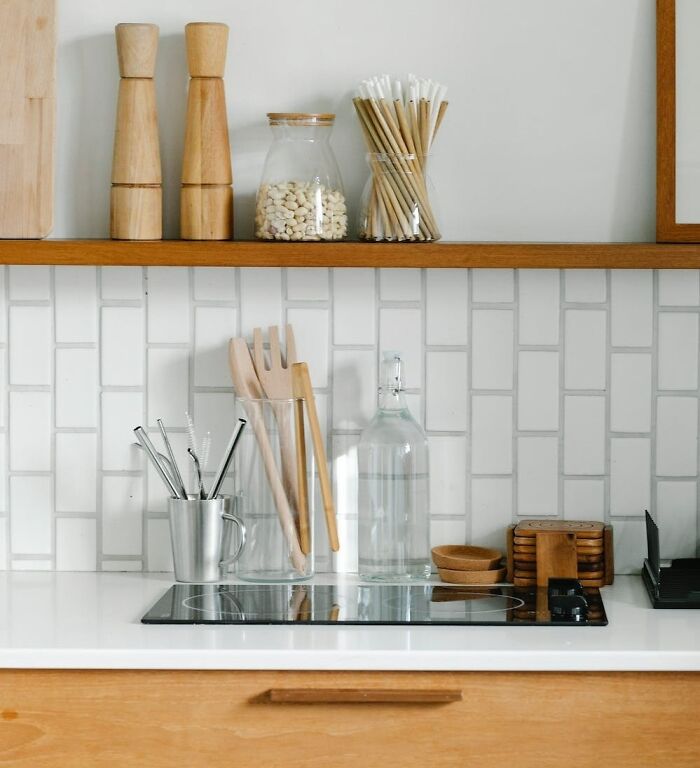 Modern kitchen countertop with organized utensils and jars, showcasing efficient home organization ideas.