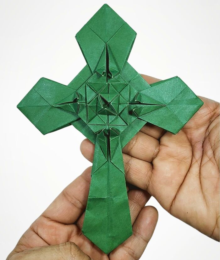 a green origami cross