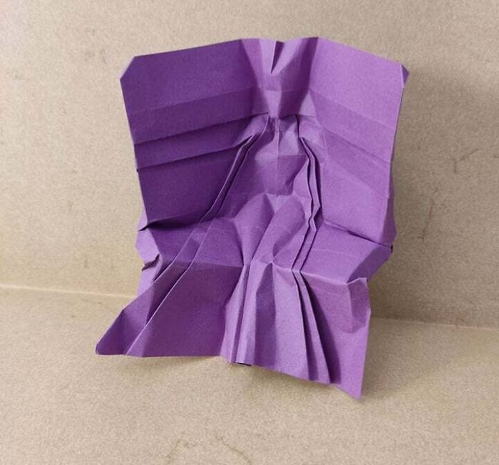 a purple origami of a postures