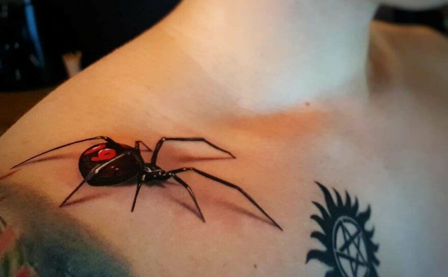 Dark spider tattoo on right shoulder