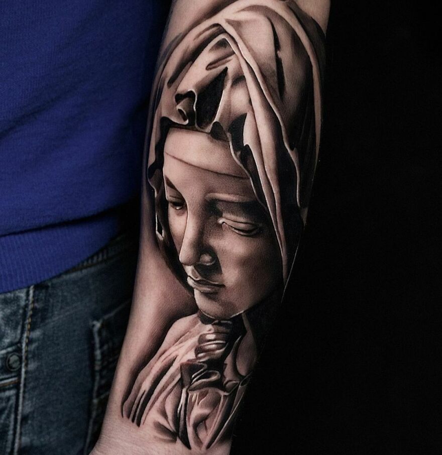 Super realistic tattoo of a detailed sculpture-like portrait on a person's arm.