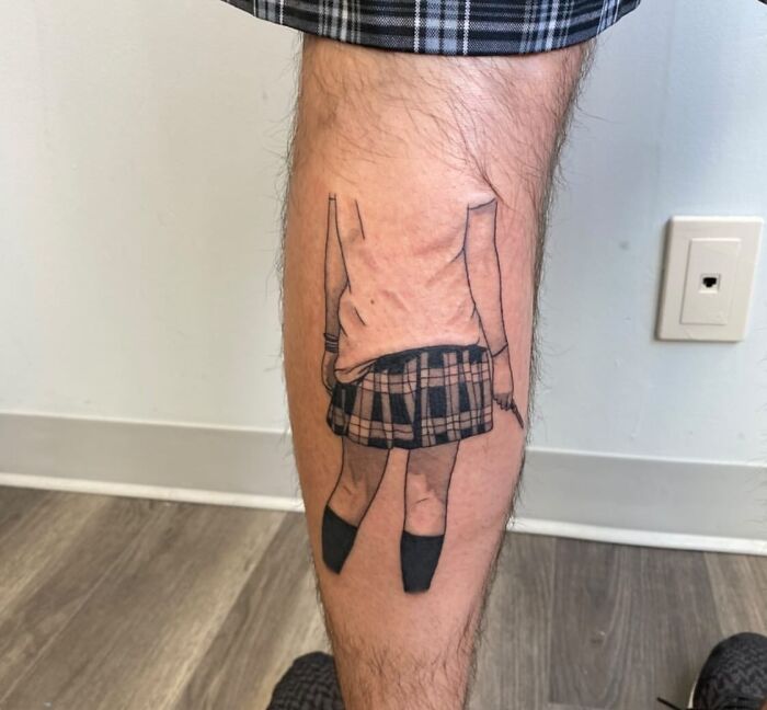 Woman with skirt calf tattoo