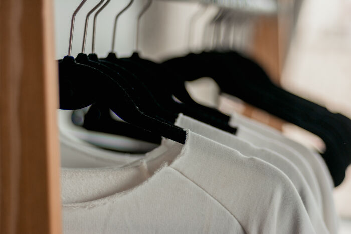 White tops hanging in the closet