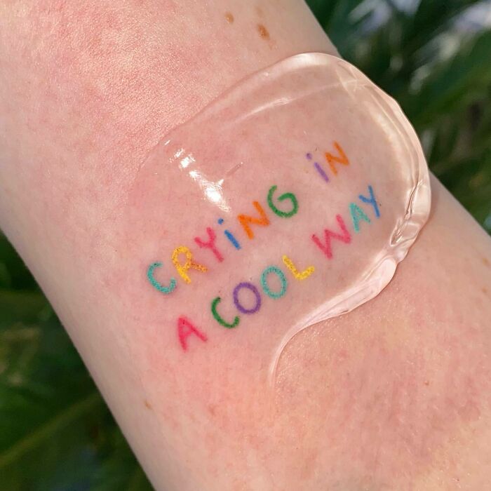 colorful crying in a cool way quote arm tattoo