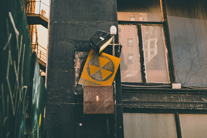 A fallout shelter sign on the building wall