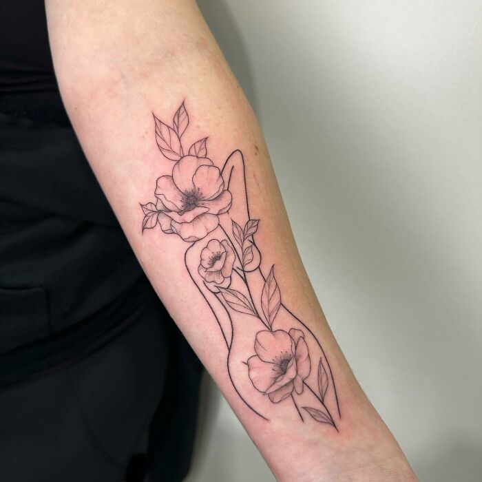 Floral self-love tattoo on forearm, emphasizing personal growth and positivity.