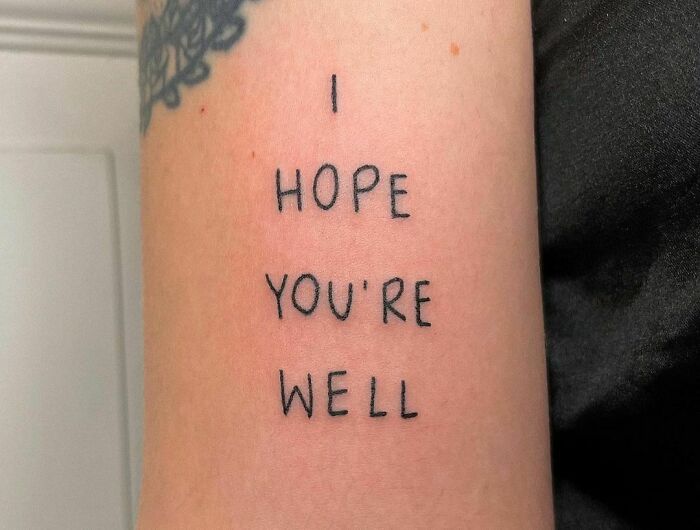 Arm with self-love tattoo reading "I hope you're well" in simple black font.