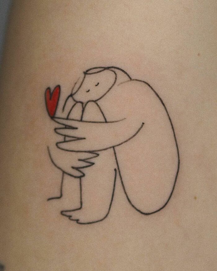 Line art self-love tattoo with a hugging figure and a red heart shape.