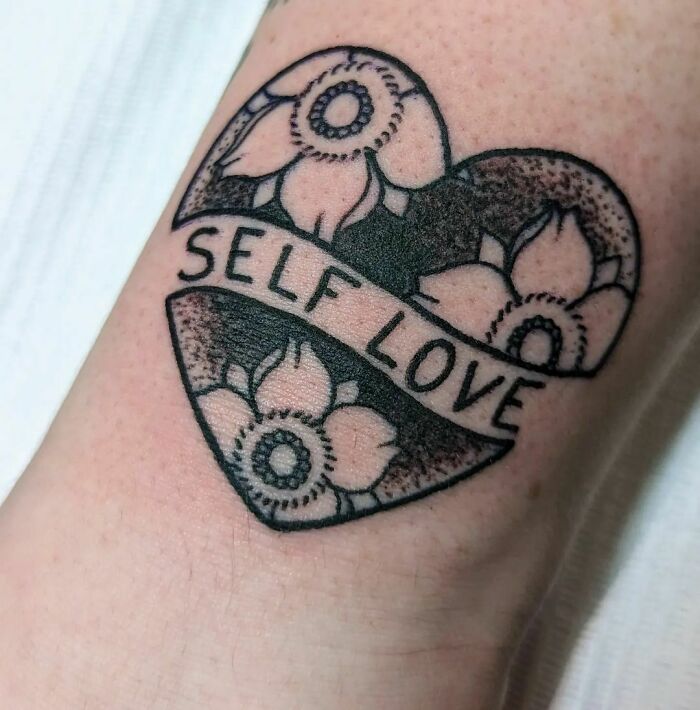 Heart full of flowers self love arm tattoo