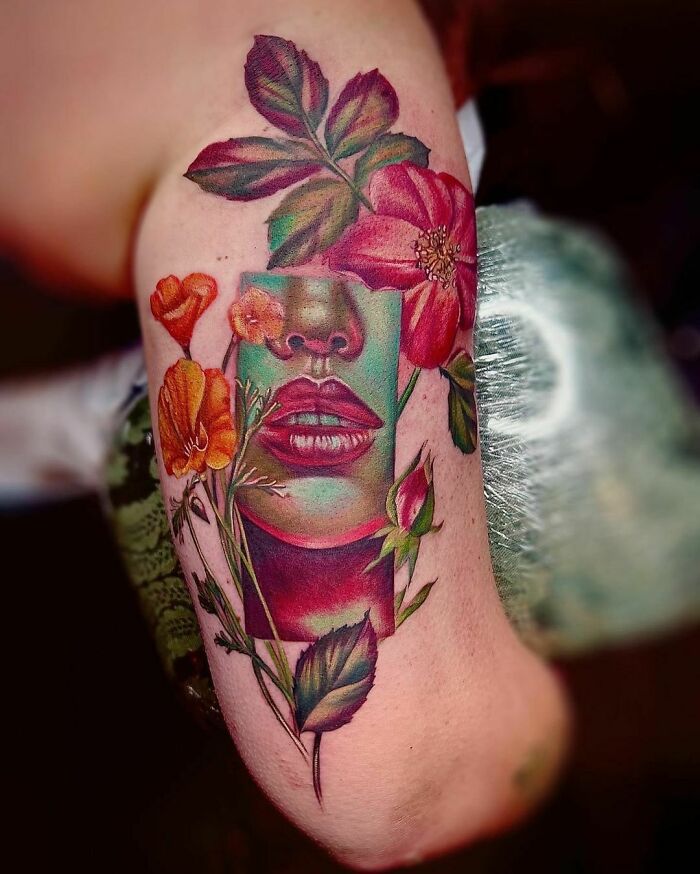 Woman lips with flowers arm tattoo