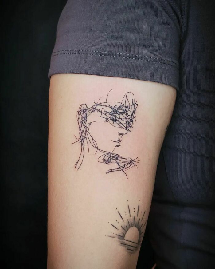 woman line arm tattoo