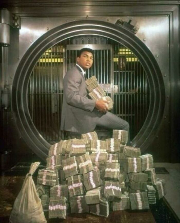 Muhammed Ali Poses With His Prize Winnings During A Photoshoot In 1964