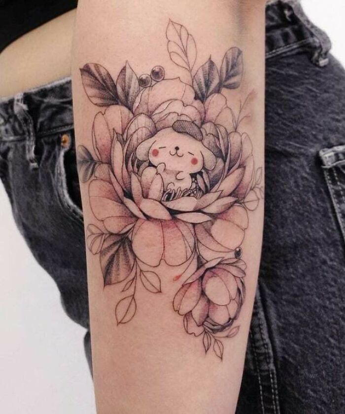 Tattoo of cute bear inside flower blossom