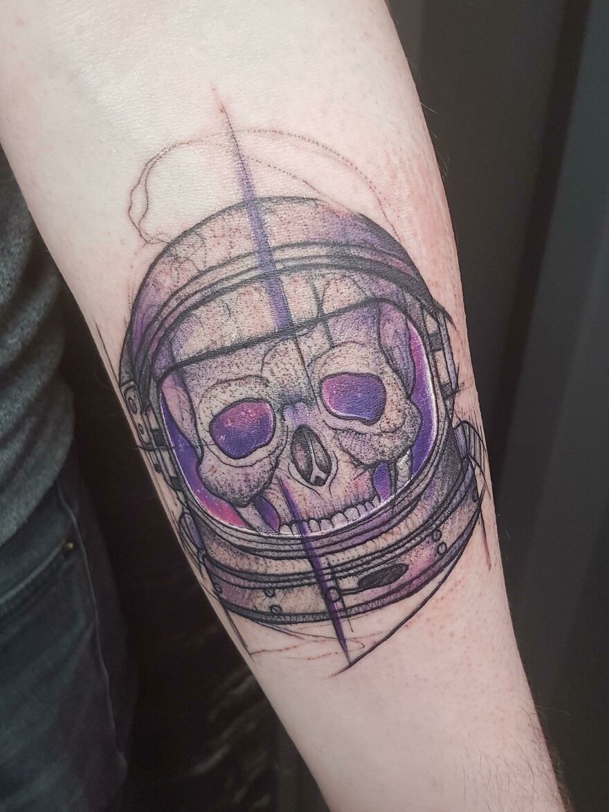 Space skull forearm tattoo