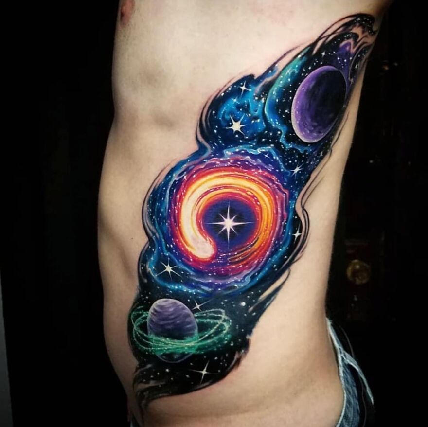Colorful galactic tattoo on the ribs