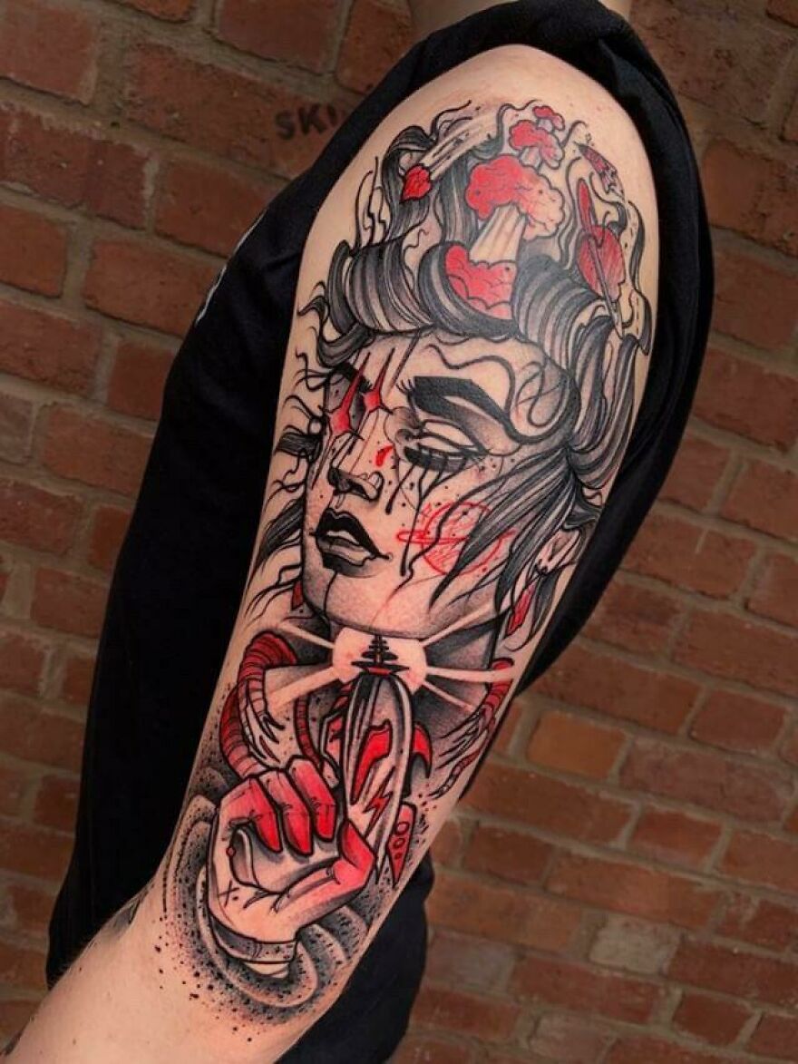 Space girl in black and red ink tattoo on the arm
