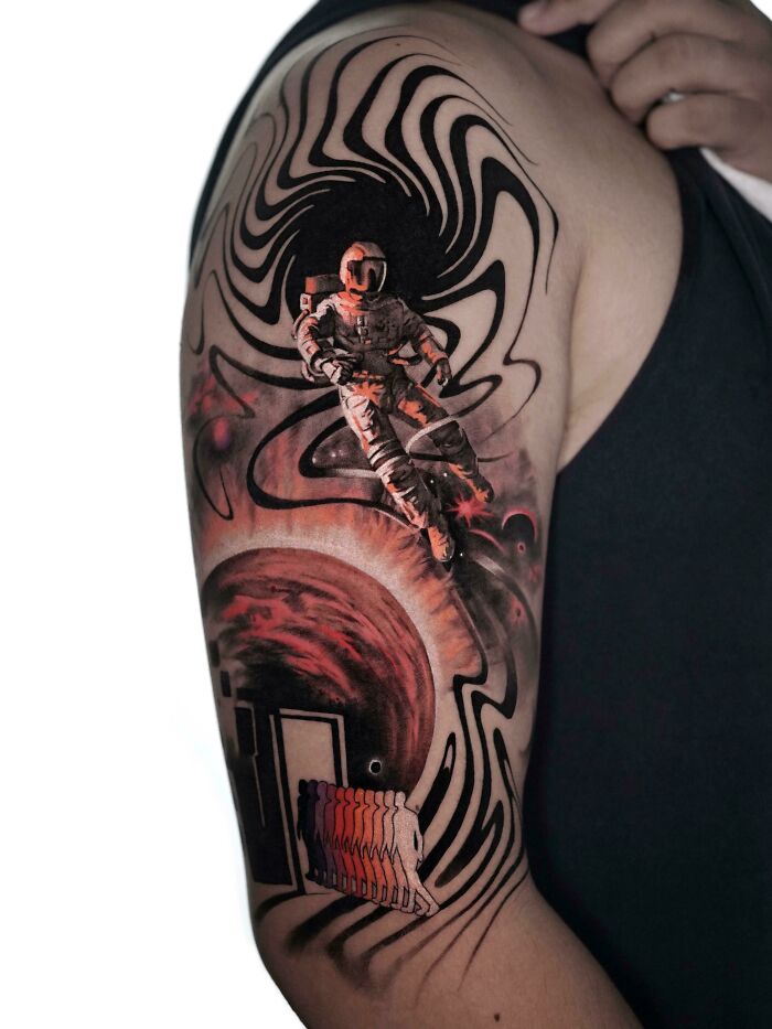 Abstract astronaut in space shoulder tattoo