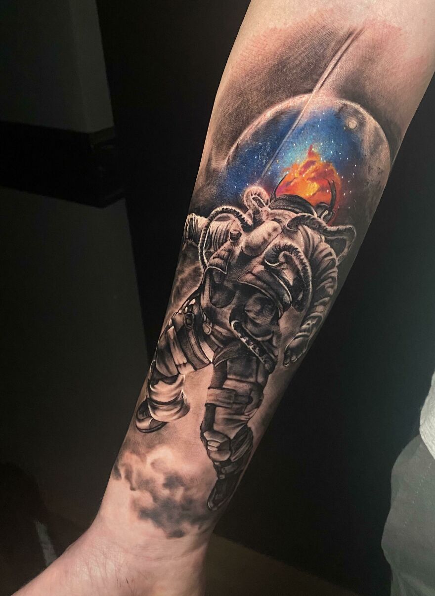 Astronaut in space forearm tattoo