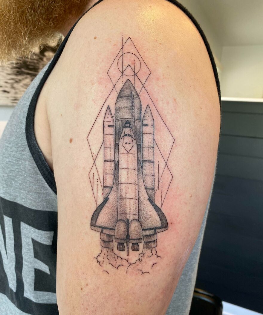 Spaceship arm tattoo with graphic elements