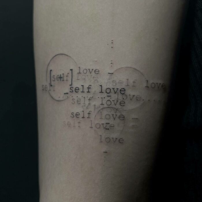 Trippy love quote arm tattoo